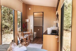 a tiny house with a kitchen and a dining room at Wally's Retreat 1 in Balingup
