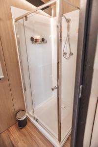 a shower with a glass door in a bathroom at Wally's Retreat 1 in Balingup