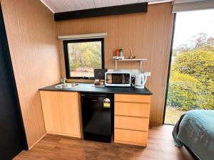 a small kitchen with a sink and a microwave at Wally's Retreat 2 in Balingup