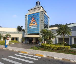 a large building with a sign on the side of it at Fermont 32 in Praia Grande