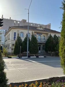 a building on the corner of a street at Guest House Medic in Nukus