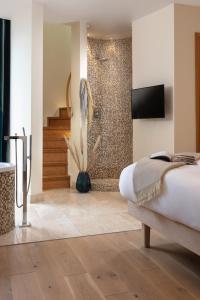 a bedroom with a shower and a bed in a room at The Scarlet Hotel in Mawgan Porth