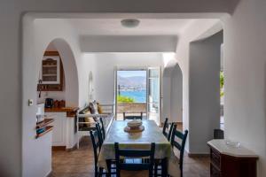 a kitchen and dining room with a table and chairs at Parikia Cove Mansion in Parikia
