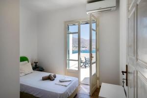 a bedroom with a bed and a view of the ocean at Parikia Cove Mansion in Parikia