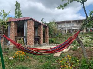 a hammock in front of a brick building at Tsivi Tba in Tsqaltubo