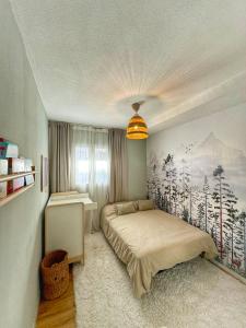 a bedroom with a bed with a painting on the wall at Duplex Penthouse with Seaview. in Benalmádena