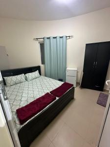 um quarto com uma cama e uma cortina azul em Palm Inn Hostel em Dubai