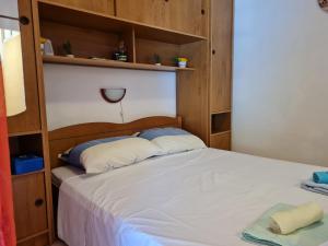 a bedroom with a bed with wooden shelves at Villa Agata in Lastovo