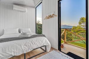 a bedroom with a bed and a large window at Montara Views 2 in Ararat