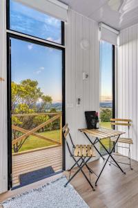 a room with a table and a chair and a large window at Montara Views 2 in Ararat