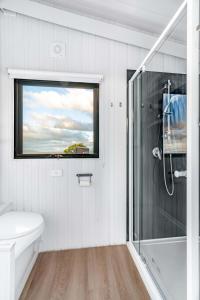 a bathroom with a shower and a toilet and a window at Montara Views 2 in Ararat