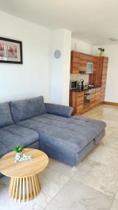 a living room with a blue couch and a table at Apartman Linda in Milna +47 photos