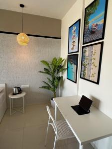 a room with a white table with a laptop on it at Ivory: 3Bhk Duplex near Balewadi High Street in Pune