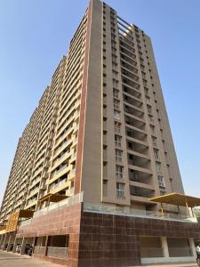 a large apartment building with a tall at Ivory: 3Bhk Duplex near Balewadi High Street in Pune