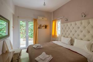 a bedroom with a large bed with two towels on it at Fantastic Matala 1 in Matala