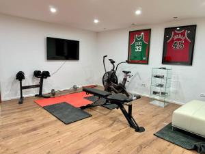 a room with a gym with a treadmill and a television at Exquisites Apartment + Terrasse in Korb