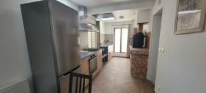 a kitchen with a refrigerator and a stove top oven at Chez Philippe et Agnès Appartement T2 in Vauciennes