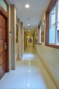 an empty hallway in a building with a door at Bentley Hotel, Marine Drive in Mumbai