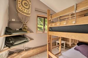 a room with two bunk beds and a window at Gite Skioura, Gite De Groupe in Superbagnères