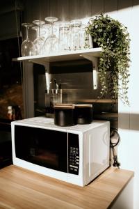 a microwave sitting on a counter in a kitchen at Hidden Creek Tiny Home in Kurrajong