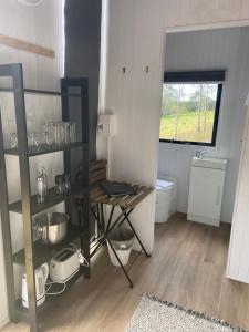 a small kitchen with a table and a window at Hill Creek 2 Tiny House in Perwillowen