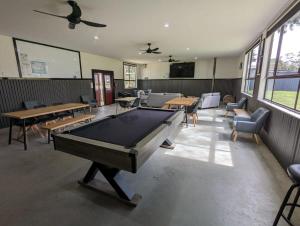 a pool table in a room with tables and chairs at Tiny House 5 at Grampians Edge in Dadswells Bridge