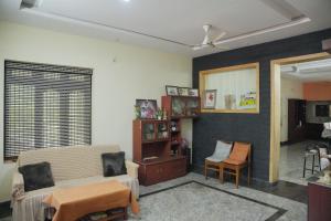 a living room with a couch and a chair at Ashiaana Homestay in Trichūr