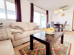 a living room with a couch and a table at Elegant apartment with stunning pool views at La Torre Golf- MO2412LT in Torre-Pacheco