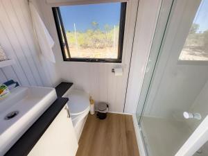 a small bathroom with a sink and a shower at Hill River Nature Reserve in Jurien Bay