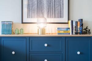 a blue dresser with a lamp on top of it at Idyllic Ambleside Retreat with Panoramic Views by LetMeStay in Ambleside