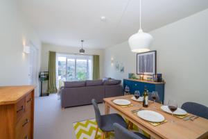 a living room with a dining table and a couch at Idyllic Ambleside Retreat with Panoramic Views by LetMeStay in Ambleside
