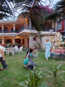 a group of people standing in front of a house at Blue Planet Lodge & Restaurant in Pokhara