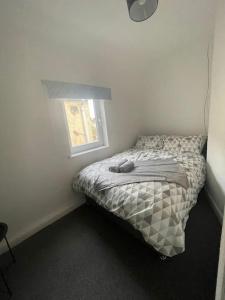 a small bed in a bedroom with a window at The Castle - Grimsby/Cleethorpes perfect for Contractors in Grimsby