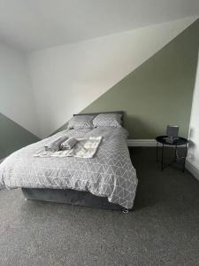 a bedroom with a bed with a white comforter at The Castle - Grimsby/Cleethorpes perfect for Contractors in Grimsby