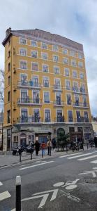a large yellow building on the side of a street at Le cocon lyonnais in Lyon
