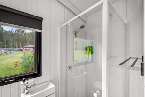 baño con ducha, lavabo y ventana en Clarence Farm Stay, en Maclean