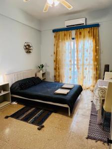 a bedroom with a large bed and a window at Past or Tail rooms in Larnaka