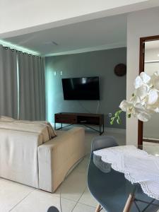 a living room with a couch and a table at Praia Grande, Angra dos Reis in Angra dos Reis