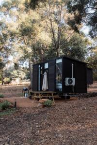 a black tiny house on a picnic table in a park at Djindarup Retreat 3 in Prevelly