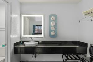 a bathroom with a sink and a mirror at Americas Best Value Inn Bangor in Bangor