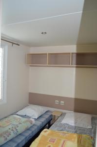 Habitación con 2 camas en una habitación en camping Le moulin en Patornay