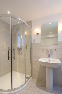 a bathroom with a shower and a sink at The Royal Lion Hotel in Lyme Regis