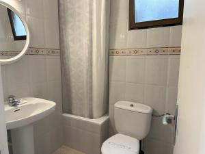 a bathroom with a toilet and a sink at Hotel Rosamar - Emar Hotels in Es Pujols