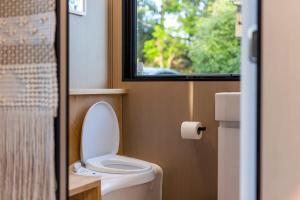 a small bathroom with a toilet and a window at Forest Hill Farm in Herbert