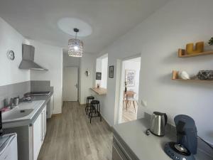 a kitchen with a sink and a counter top at ღ L'Échappée Belle - Niché au cœur de Montélimar in Montélimar