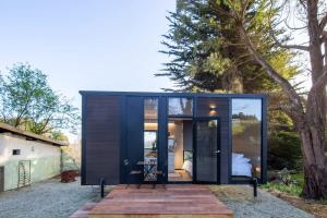 a small black shipping container with a wooden deck at Forest Hill Farm in Herbert