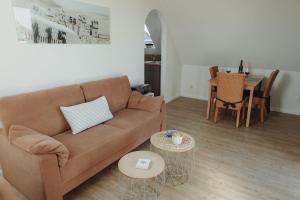 a living room with a couch and a table at Gästehaus Bröcker Wohnung 7 in Büsum