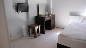 a bedroom with a bed and a desk with a mirror at Simon Hotel in Istanbul