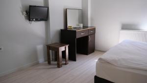 a bedroom with a bed and a dresser with a mirror at Simon Hotel in Istanbul