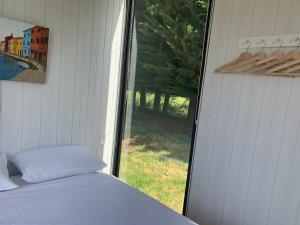 a bedroom with a bed and a window with a view at Arariri River Rest in Springston